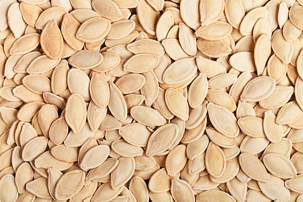 Closeup of pumpkin seeds, food background, top view